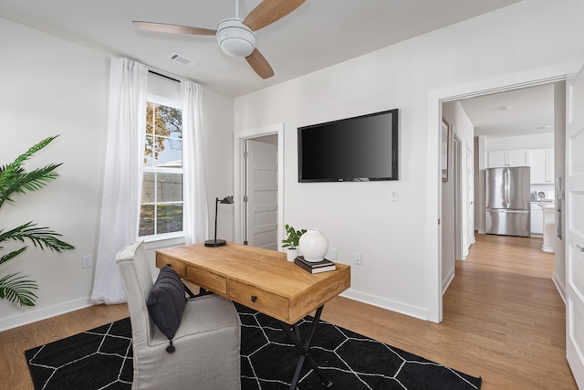 office space with light hardwood / wood-style flooring and ceiling fan