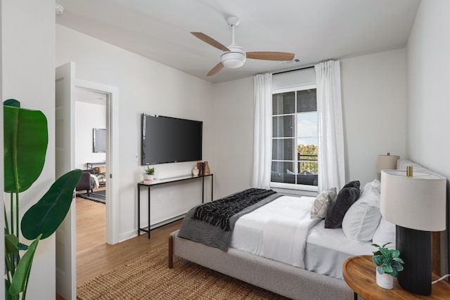 bedroom with ceiling fan and hardwood / wood-style floors