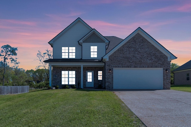 traditional home featuring concrete driveway, brick siding, a yard, and a garage