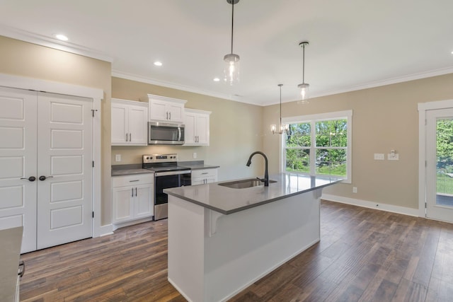 kitchen with white cabinets, a healthy amount of sunlight, a sink, dark wood-type flooring, and appliances with stainless steel finishes