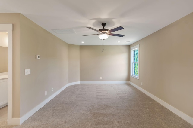 unfurnished room featuring light colored carpet, baseboards, a ceiling fan, and recessed lighting