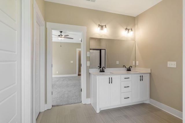 bathroom with double vanity, visible vents, a sink, and ceiling fan