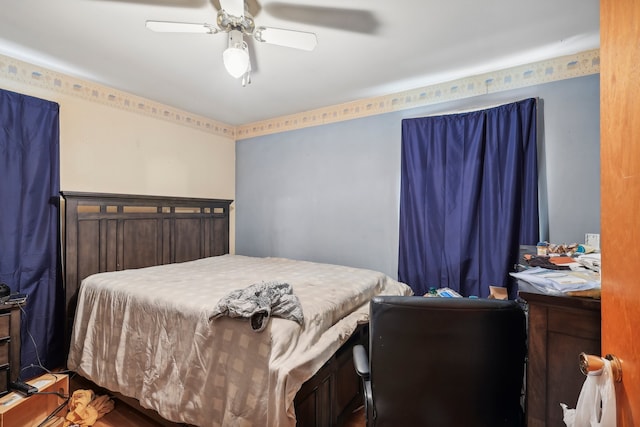 bedroom with hardwood / wood-style floors and ceiling fan