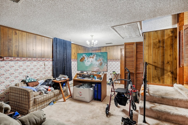 misc room with light carpet, an inviting chandelier, wood walls, and a textured ceiling