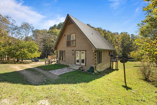 rear view of property with a lawn