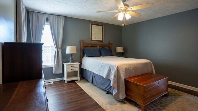 bedroom featuring a textured ceiling, ceiling fan, and dark hardwood / wood-style flooring