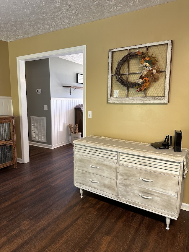 room details featuring a textured ceiling and hardwood / wood-style flooring