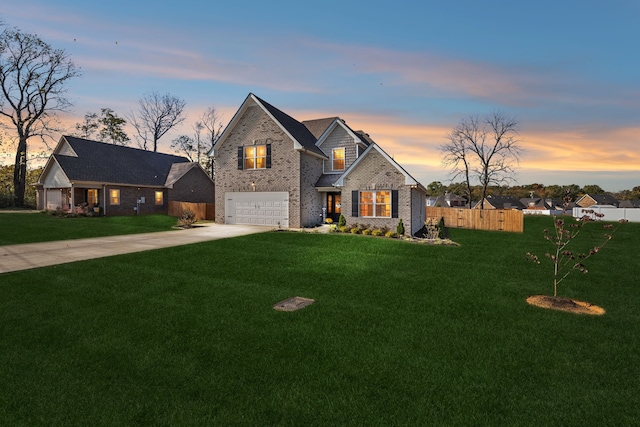 view of front of home with a yard and a garage