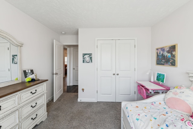 bedroom featuring a closet, a textured ceiling, and dark carpet