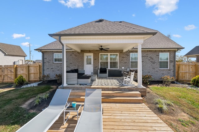 rear view of house featuring outdoor lounge area, a wooden deck, and ceiling fan