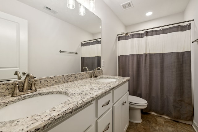 bathroom with vanity, a shower with shower curtain, and toilet