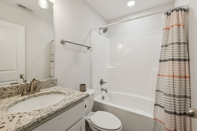 full bathroom with toilet, vanity, and shower / tub combo