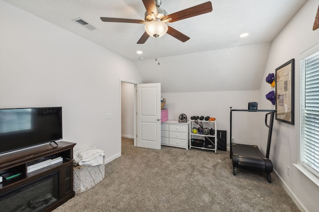 living area featuring carpet flooring, lofted ceiling, a wealth of natural light, and ceiling fan