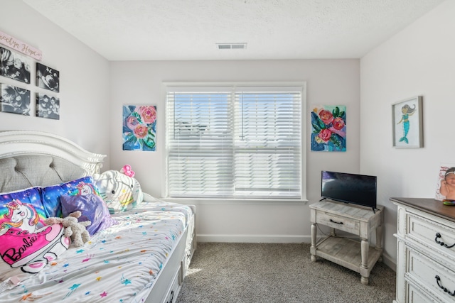 carpeted bedroom featuring a textured ceiling