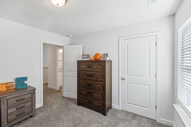 carpeted bedroom featuring a textured ceiling