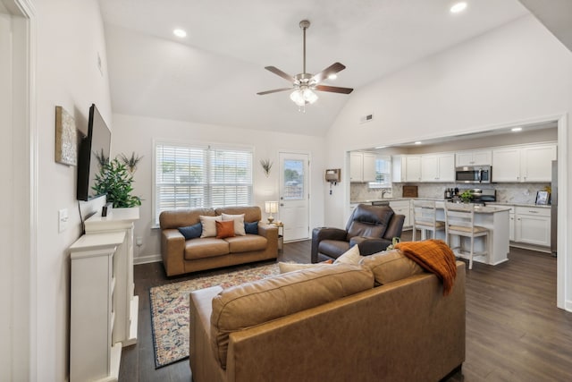 living room with ceiling fan, high vaulted ceiling, sink, and dark hardwood / wood-style flooring