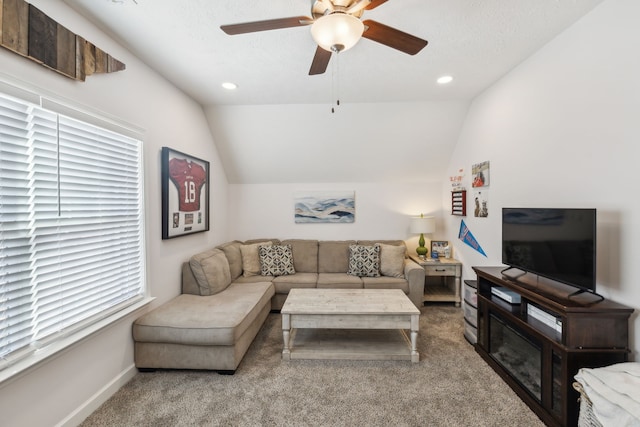 living room featuring light carpet, a healthy amount of sunlight, ceiling fan, and vaulted ceiling