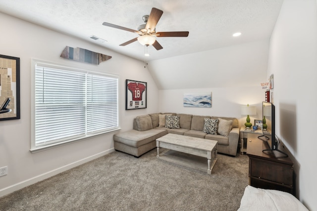 carpeted living room featuring lofted ceiling, a textured ceiling, and ceiling fan