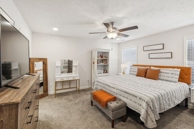 bedroom featuring ceiling fan, carpet, and multiple windows