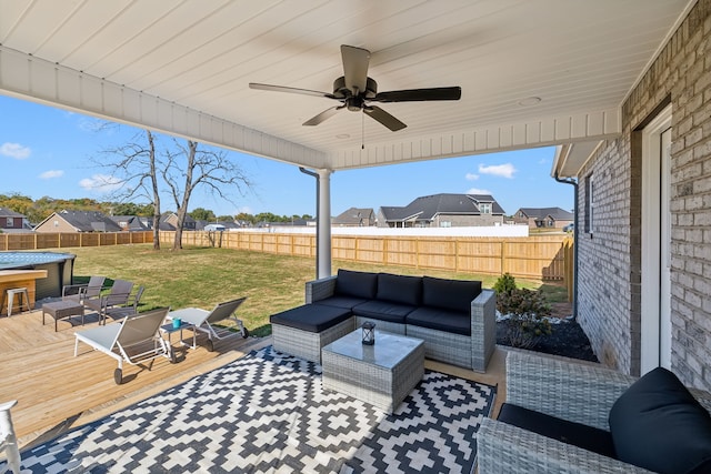 view of patio with an outdoor living space, a deck, and ceiling fan