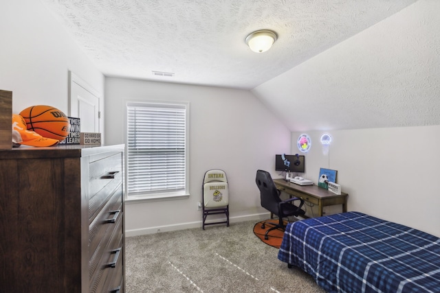 carpeted bedroom with lofted ceiling and a textured ceiling