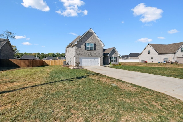 view of front of house with a front yard, central AC unit, and a garage