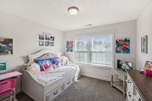 bedroom featuring dark colored carpet and a textured ceiling