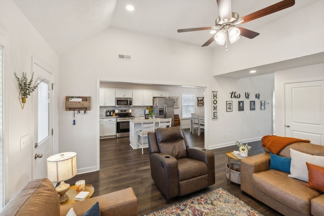 living room with ceiling fan, high vaulted ceiling, and dark hardwood / wood-style floors