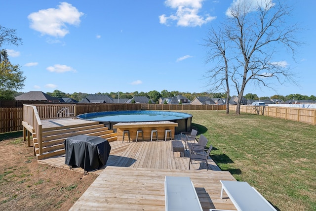 exterior space with a fenced in pool, a yard, and grilling area