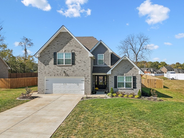 view of front of property with a front yard and a garage