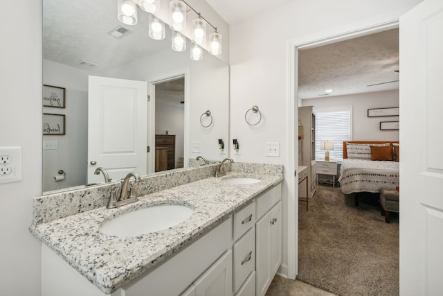 bathroom featuring vanity and a textured ceiling