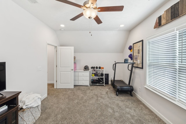 exercise room with lofted ceiling, light carpet, and ceiling fan