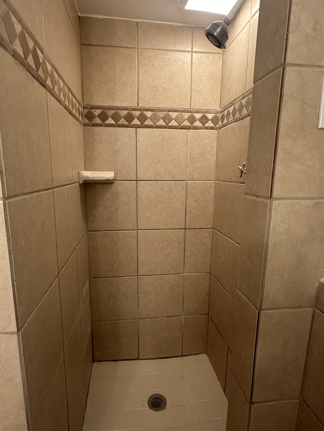 bathroom with tiled shower