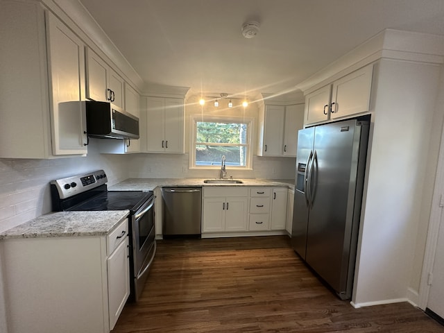 kitchen featuring white cabinets, appliances with stainless steel finishes, sink, and dark hardwood / wood-style flooring