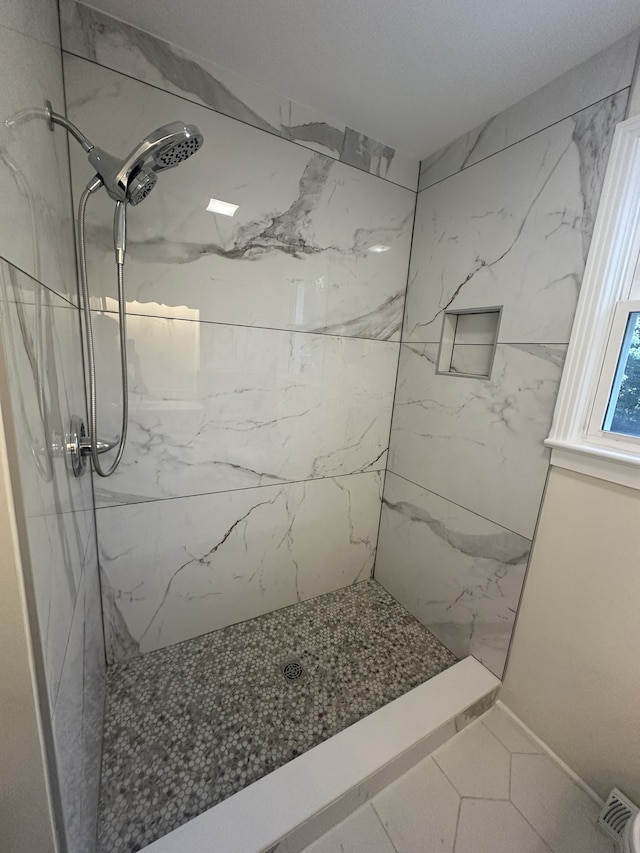 bathroom with a tile shower