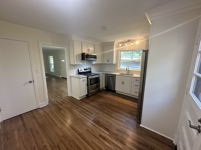 kitchen featuring white cabinetry, appliances with stainless steel finishes, sink, and dark hardwood / wood-style floors