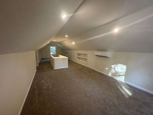 bonus room with built in features, dark carpet, vaulted ceiling, and a wall unit AC