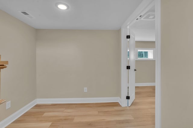 unfurnished room with light wood-type flooring