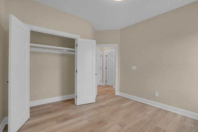 unfurnished bedroom featuring a closet and light hardwood / wood-style flooring