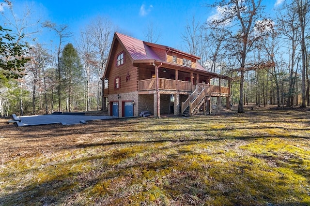 rear view of house with a garage and a yard