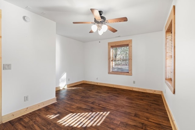 unfurnished room featuring dark wood-type flooring and ceiling fan