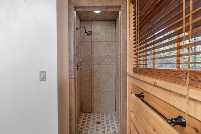 bathroom with a tile shower