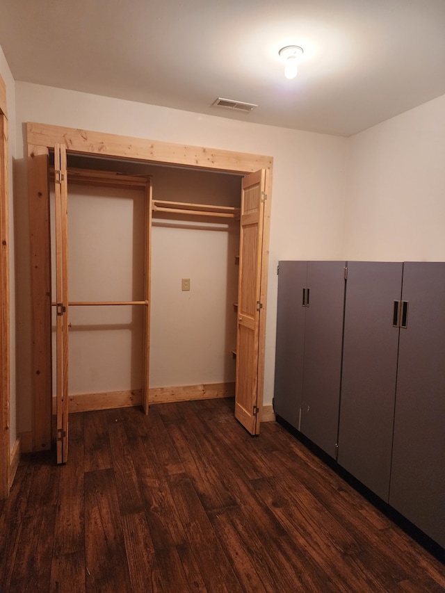 unfurnished bedroom featuring dark wood-type flooring