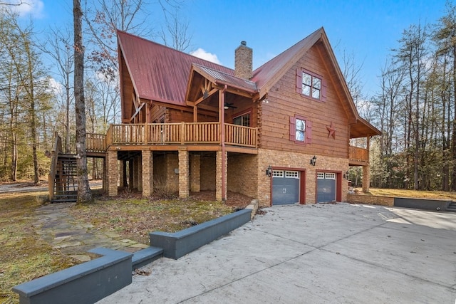 view of front facade featuring a wooden deck and a garage