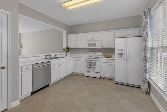 kitchen with white appliances, sink, and white cabinets