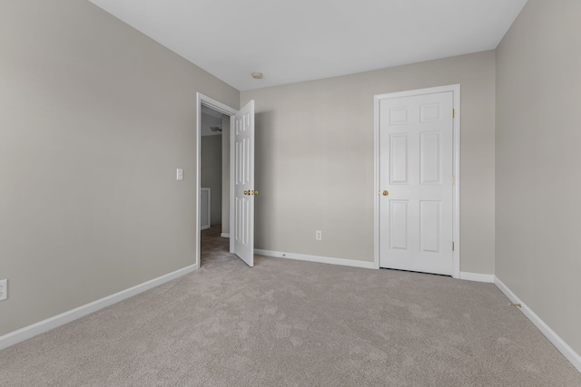 unfurnished bedroom with light colored carpet