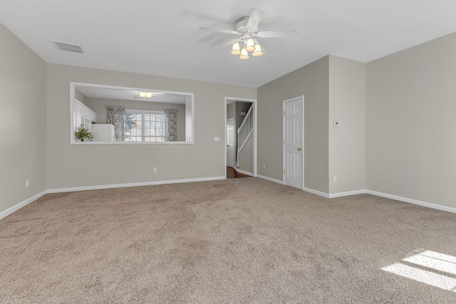 empty room with ceiling fan and carpet