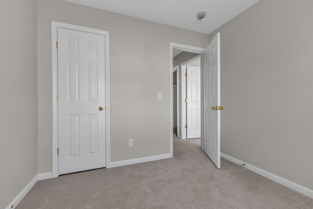 unfurnished bedroom with light colored carpet