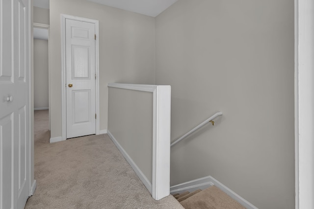 hallway with light colored carpet