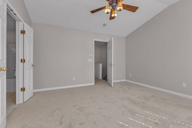 unfurnished bedroom featuring light carpet, vaulted ceiling, and ceiling fan